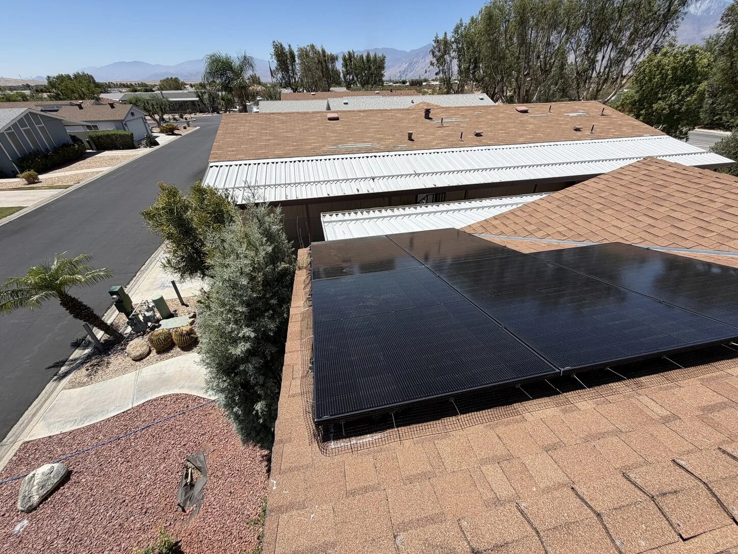 Job photo: a cleaned black solar array on a Desert Hot Springs shingle roof