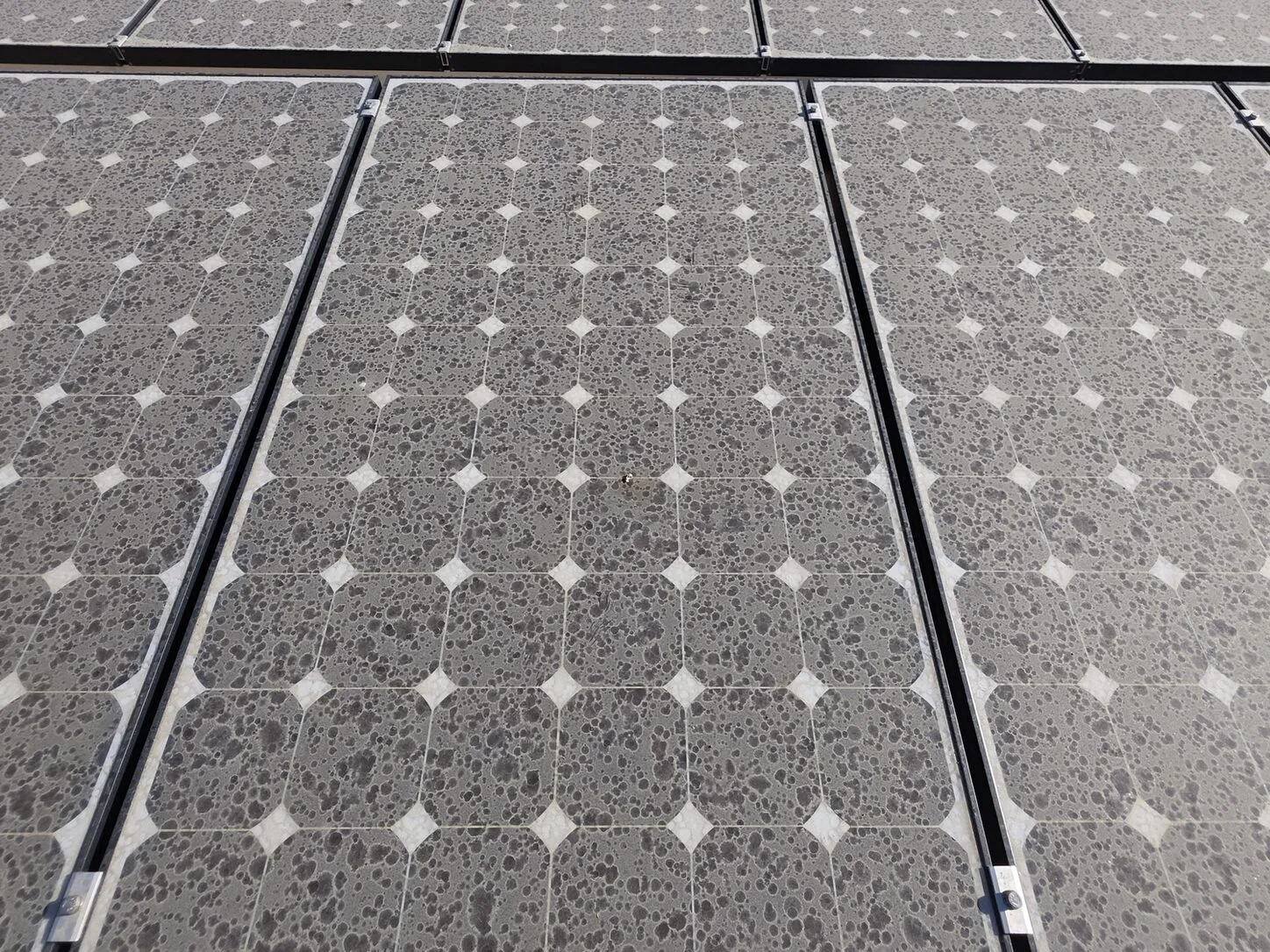 Job photo: a close-up of desert dust caked on solar cells in Rancho Mirage