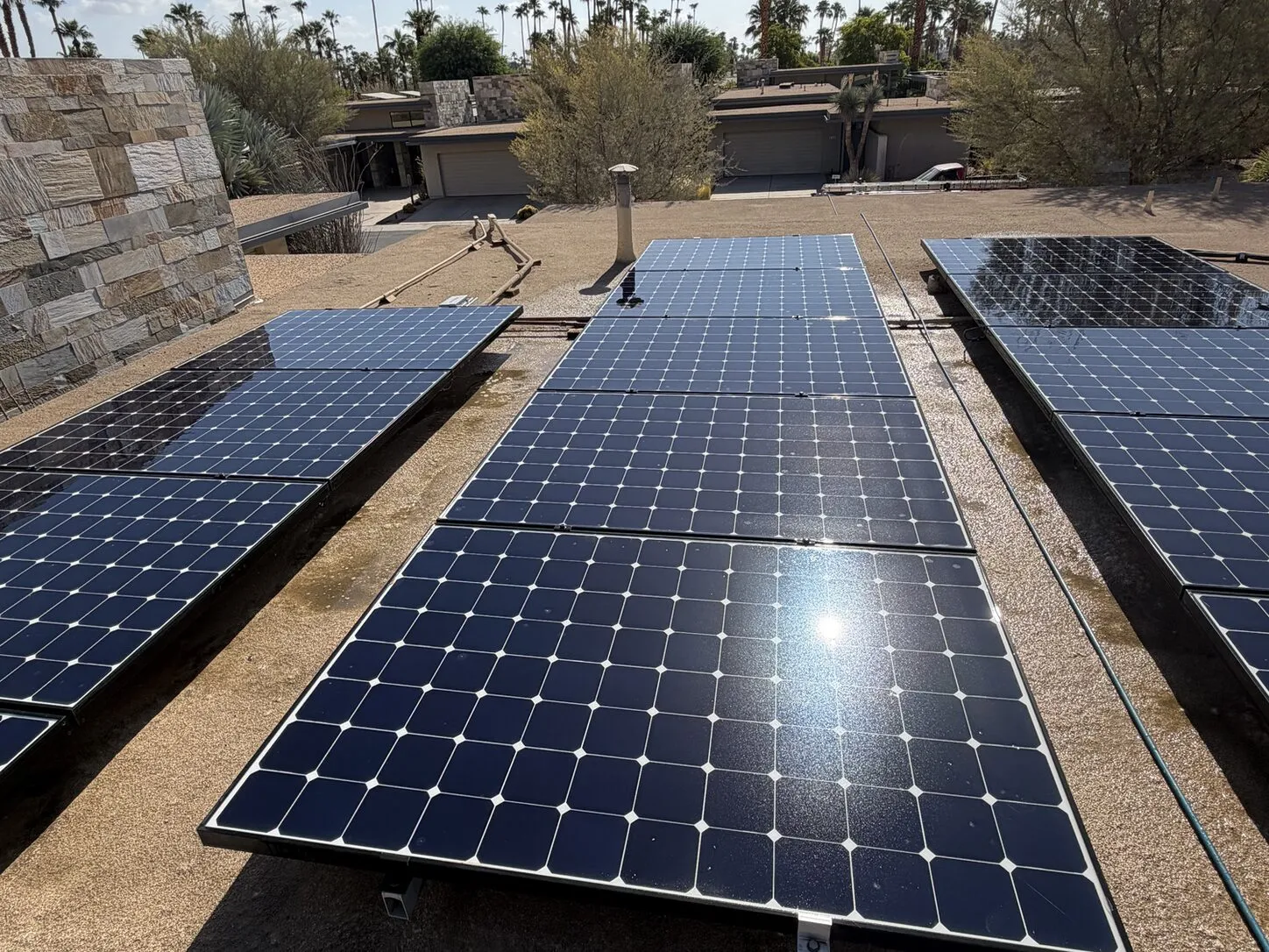 Job photo: cleaned solar rows around a skylight on a Palm Springs flat roof