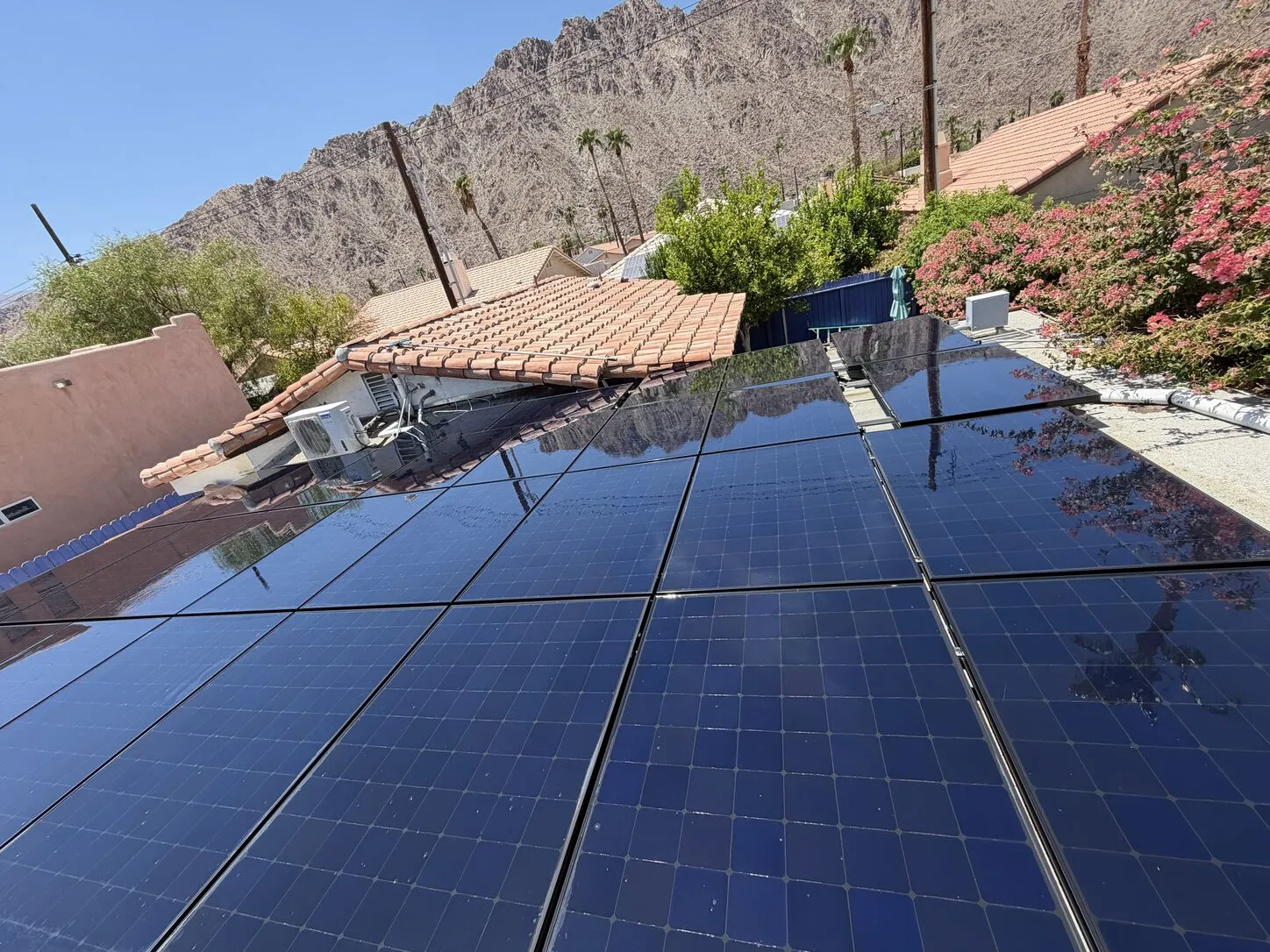 Job photo: a dusty solar array below the La Quinta mountains, and the same array cleaned and glossy
