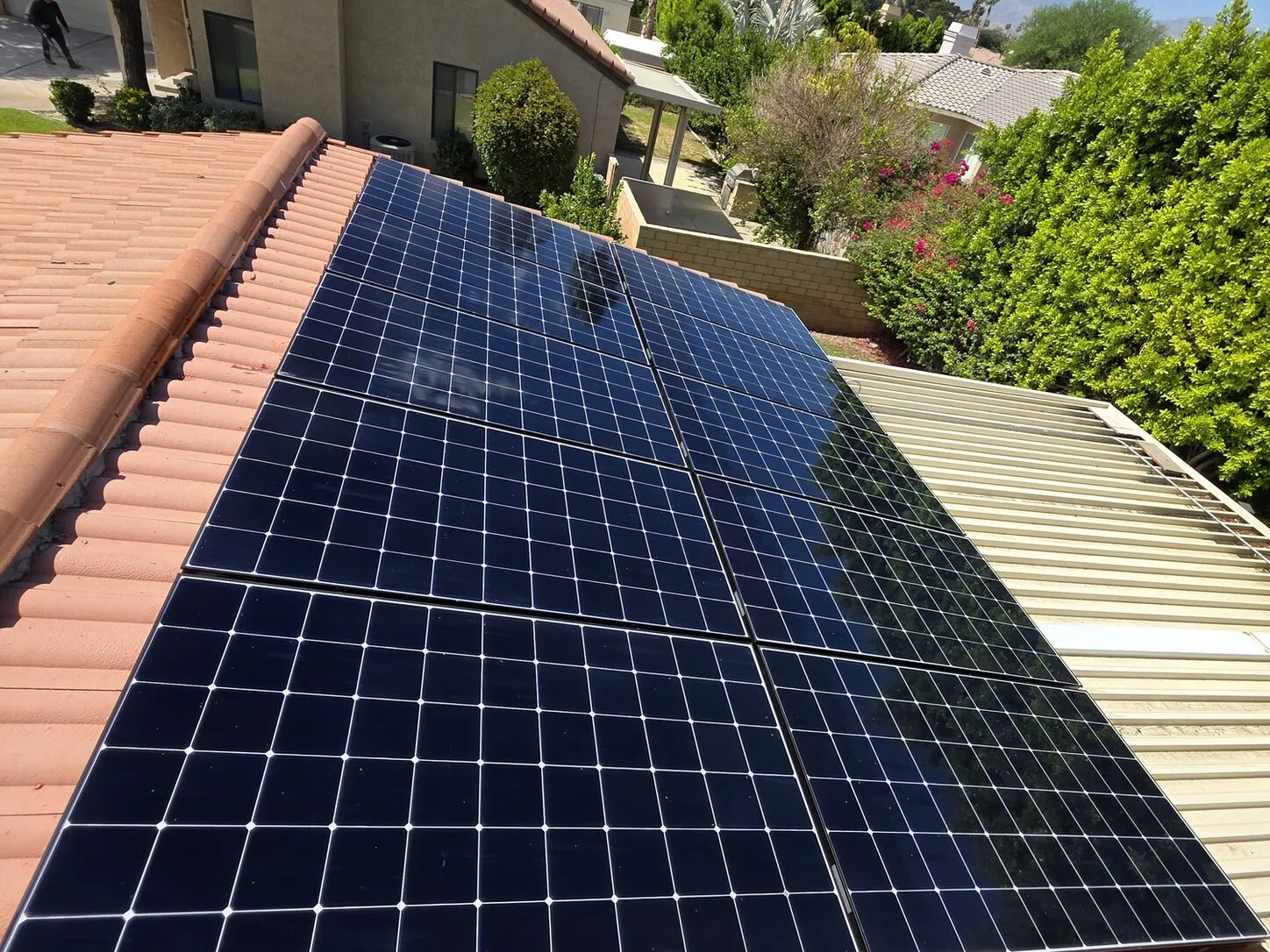 Job photo: a freshly cleaned solar array on a Palm Desert clay-tile roof