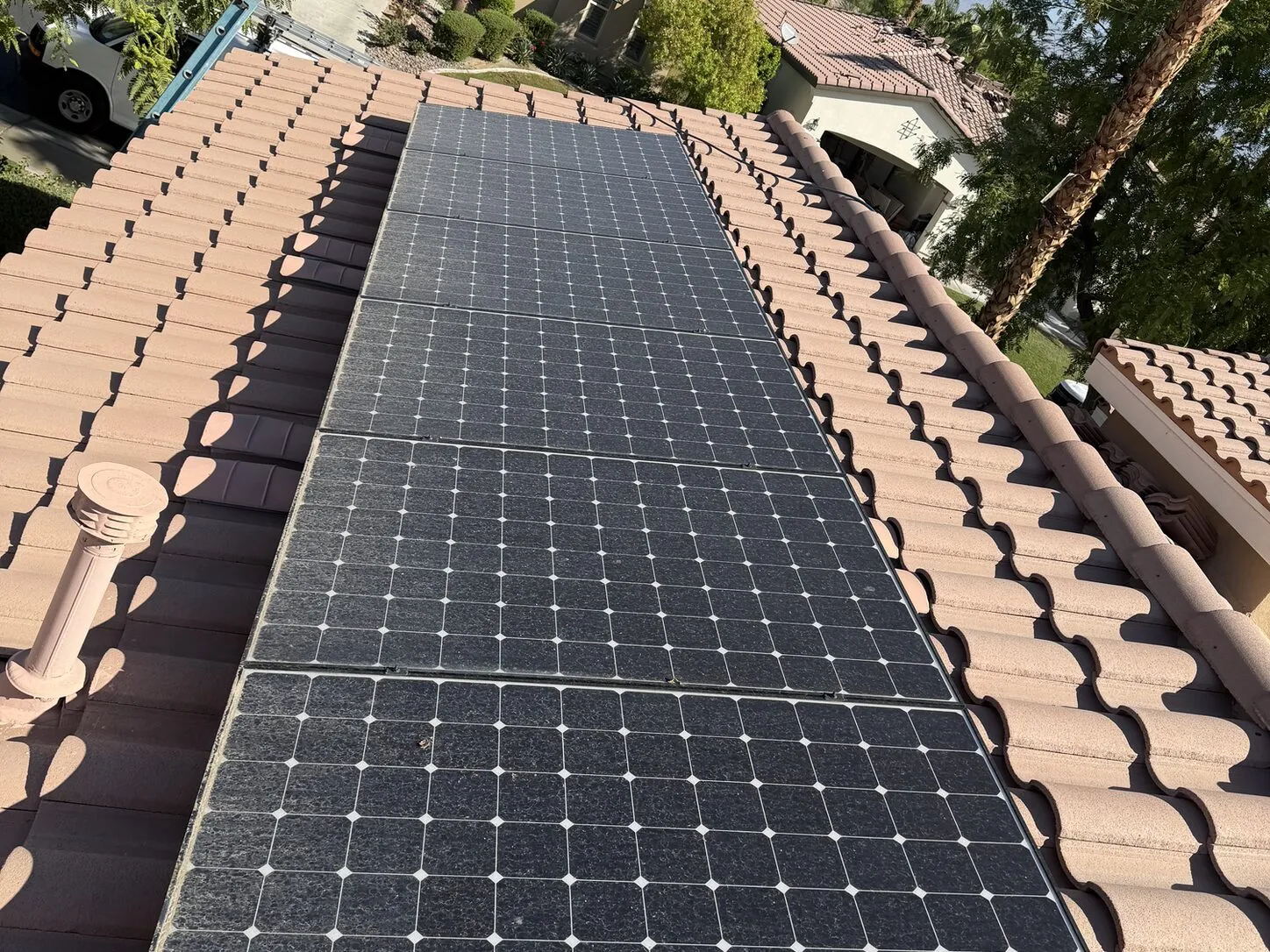 Job photo: a freshly cleaned solar array on a La Quinta clay-tile roof