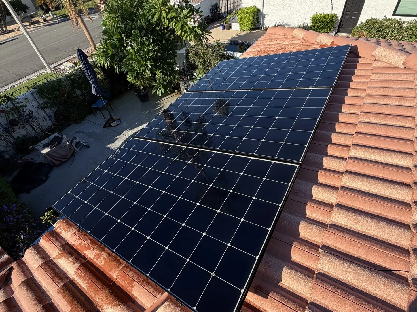 Job photo: a freshly cleaned solar array on a Palm Desert clay-tile roof