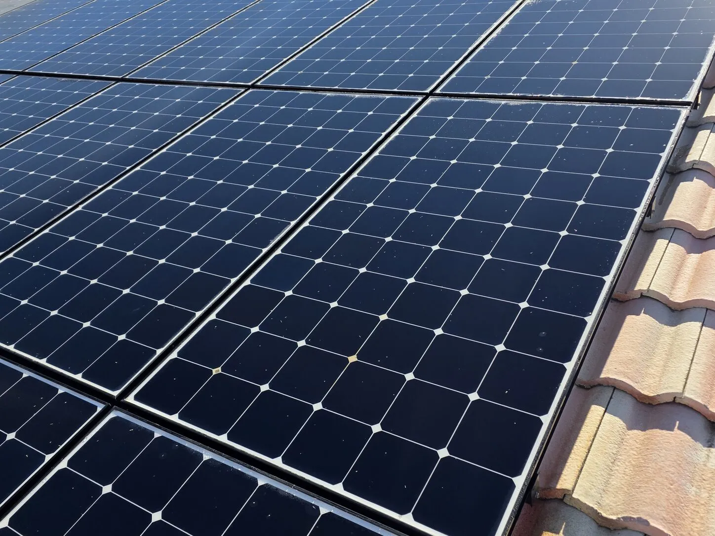 Job photo: a freshly cleaned solar array on a Cathedral City clay-tile roof
