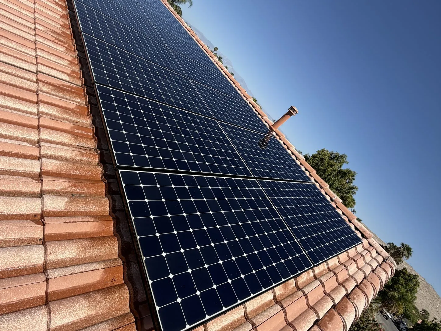 Job photo: a freshly cleaned solar array on a Cathedral City clay-tile roof