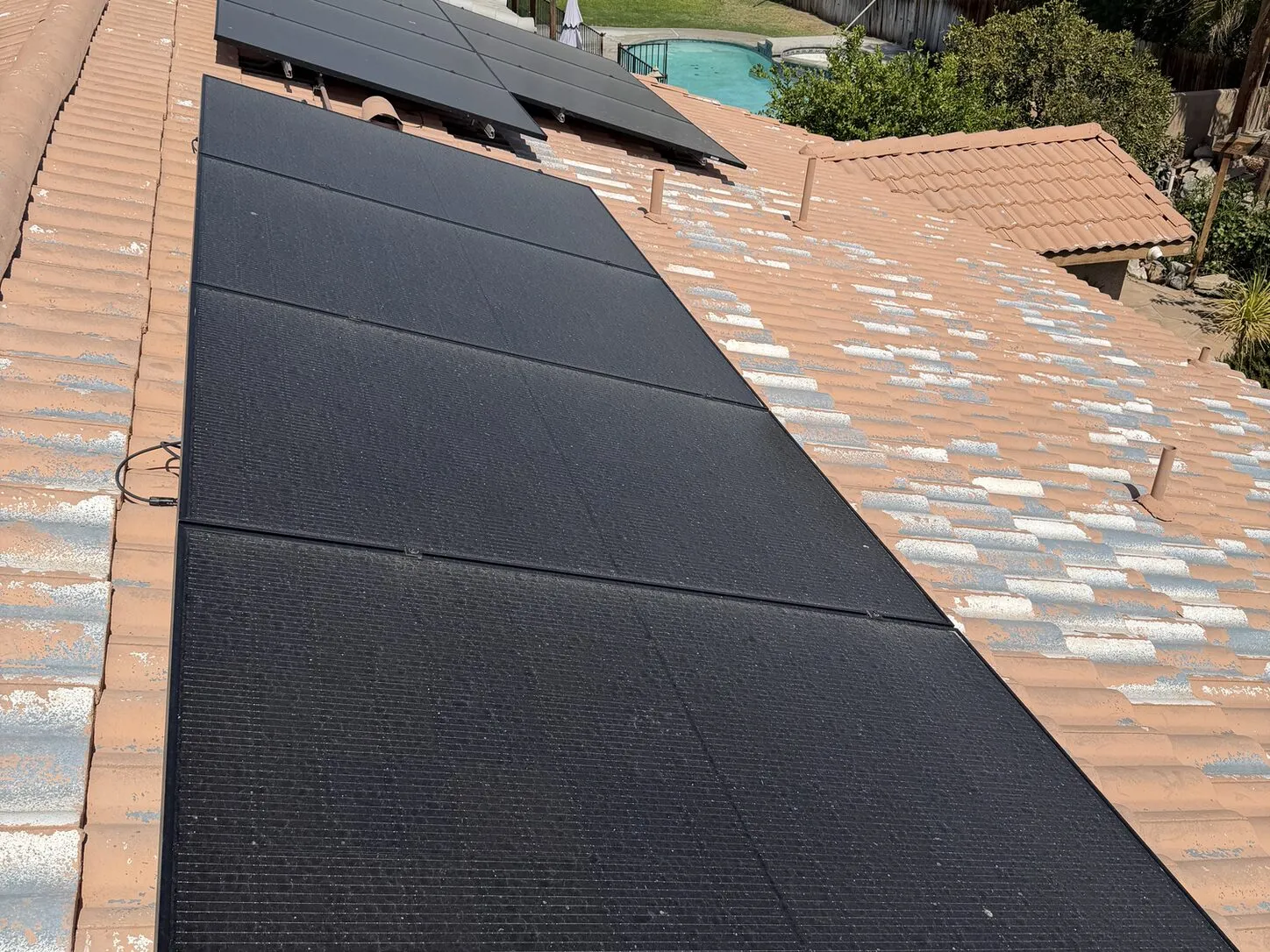 Job photo: a freshly cleaned solar array on a Cathedral City tile roof