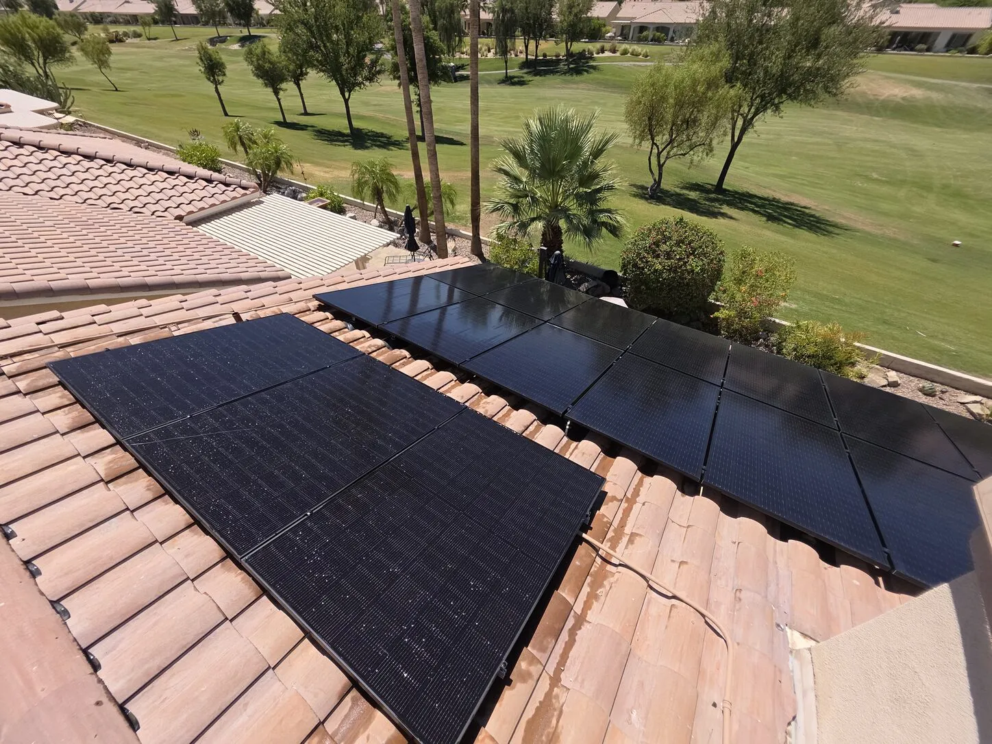Job photo: freshly cleaned solar panels on an Indio tile roof beside a golf course