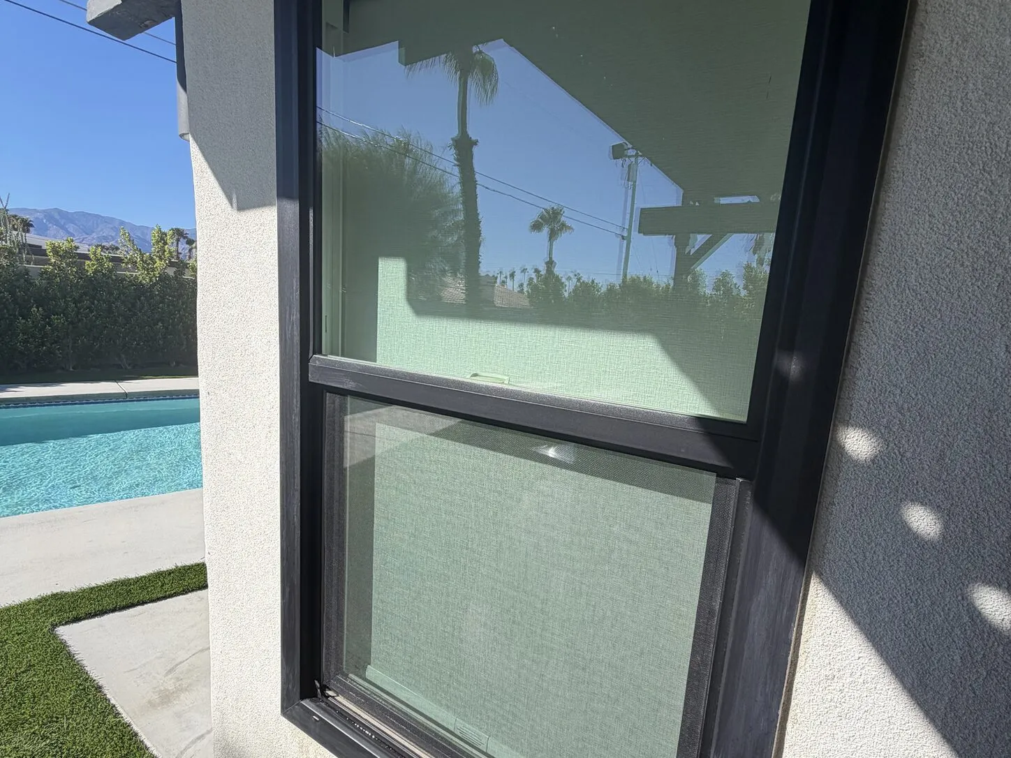 Job photo: clean black-framed windows beside a pool at a modern Palm Springs home